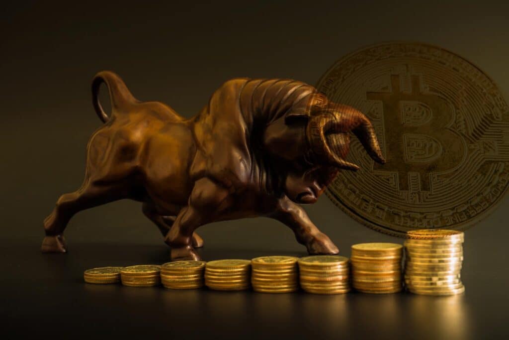 Bull-posing-next-to-Bitcoin-BTC-gold-coins-with-Logo-Bitcoin-background