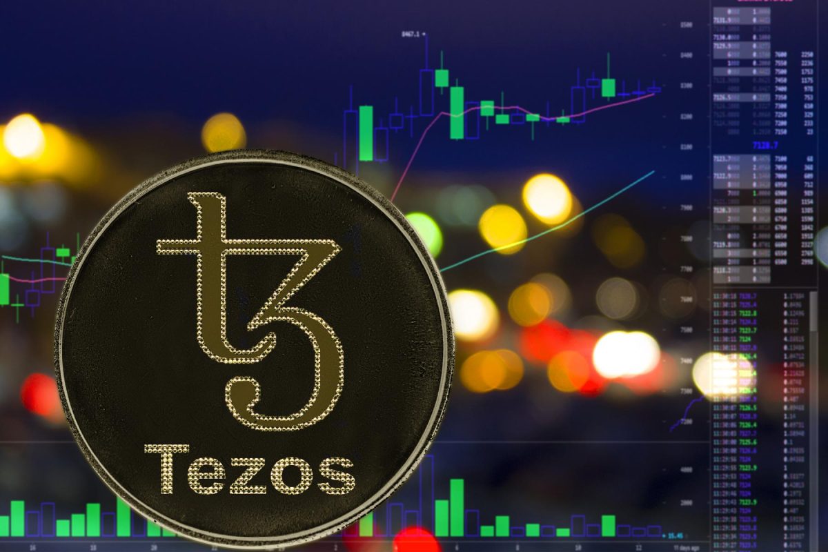 Tezos-XTZ-logo-with-background-of-trading-price-charts