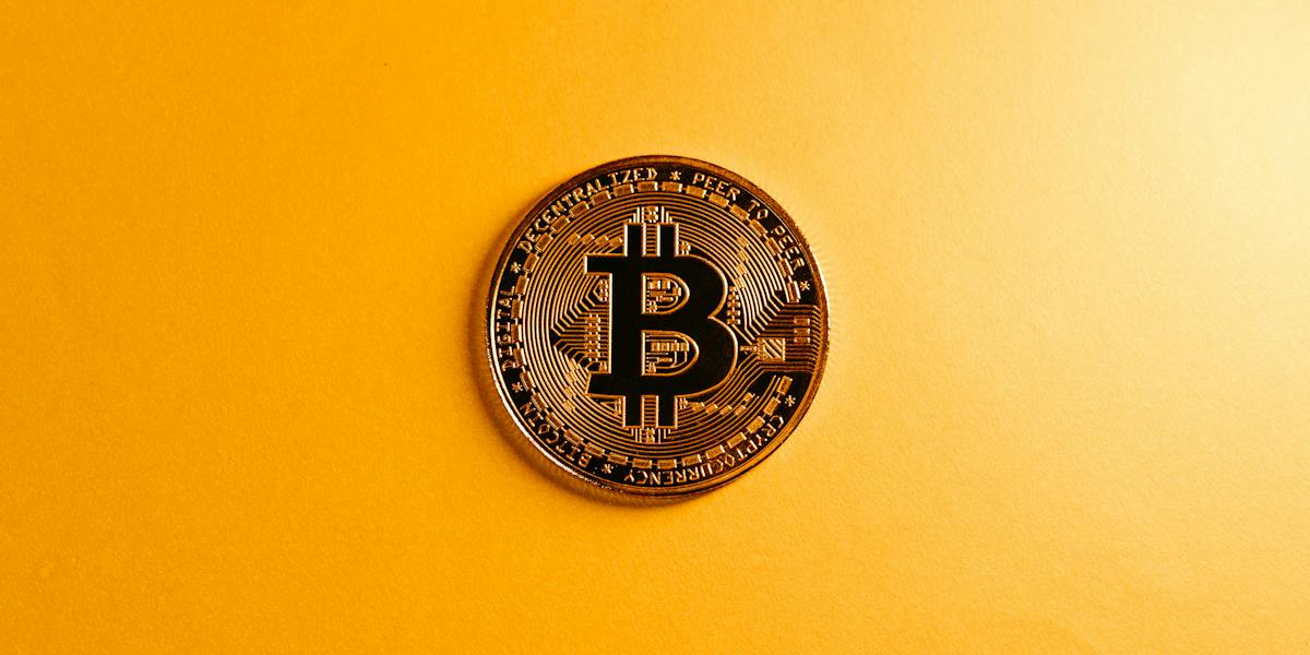 currency-bitcoin-yellow-background